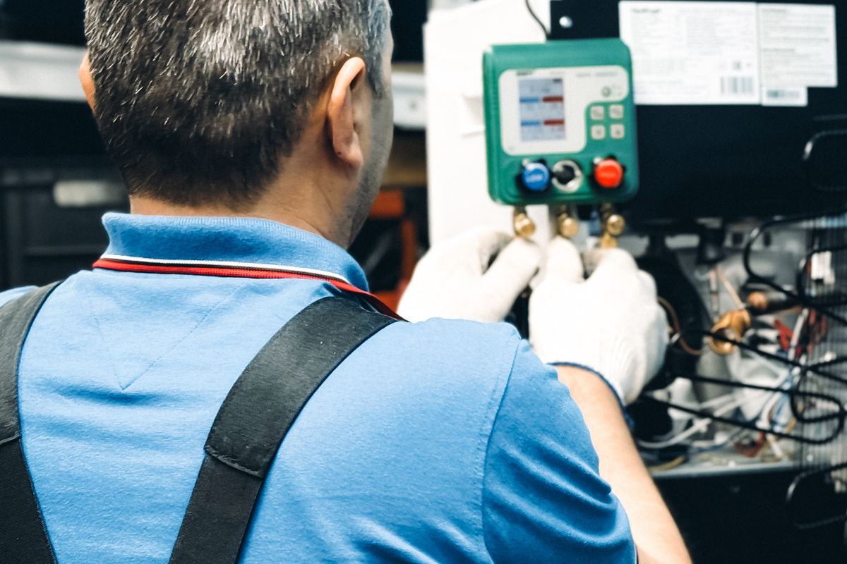 Technician checking air-conditioning service gauges